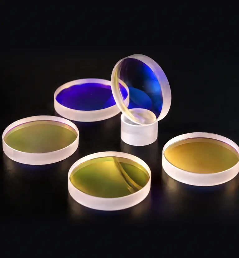 Fiber laser cutting optical lenses with coated surfaces for laser cutting heads