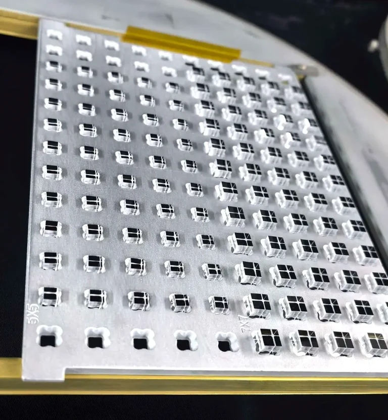 Small precision laser optical components arranged in a production fixture
